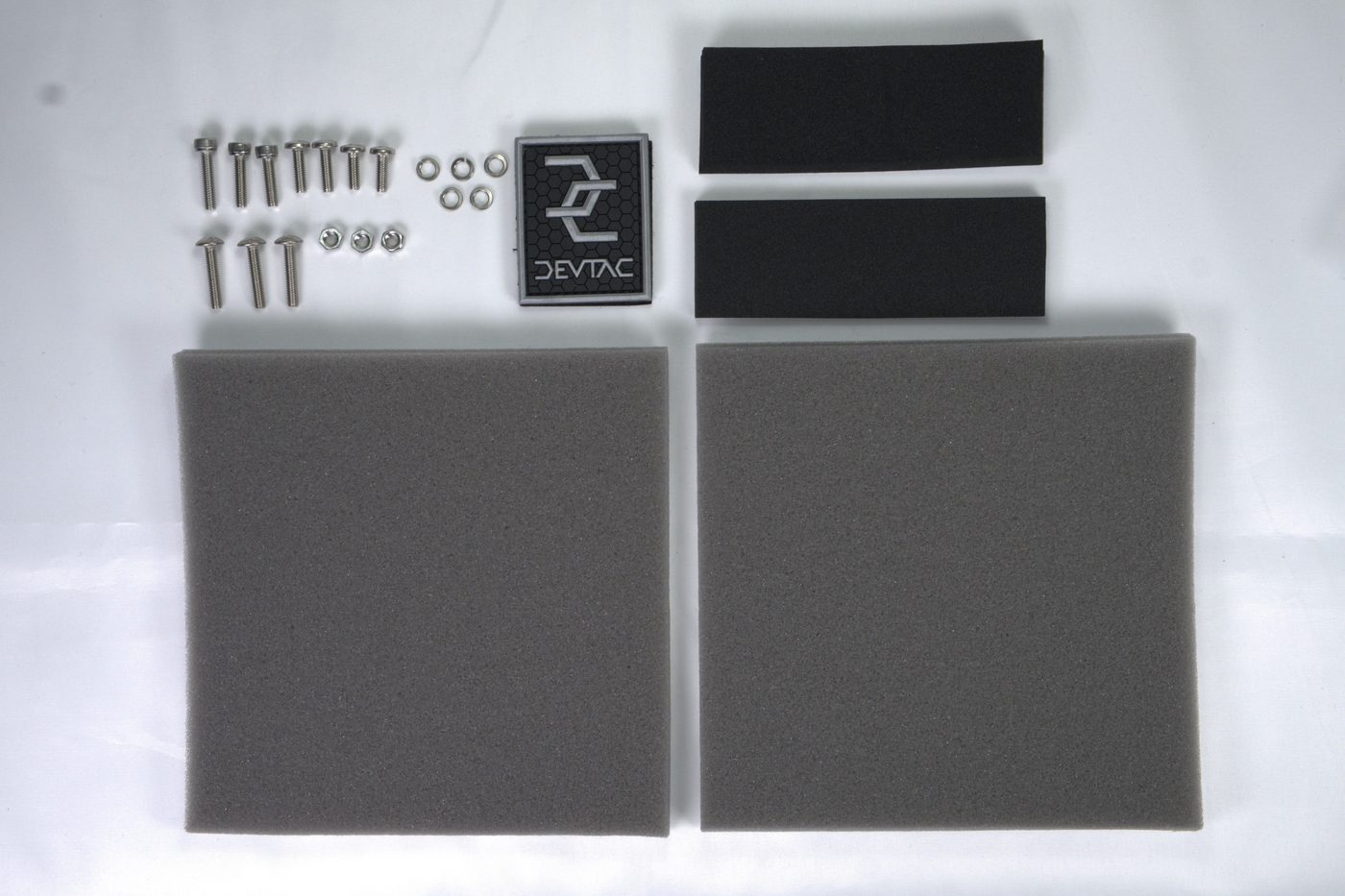 Devtac Ronin hardware set: screws, washers, foam pads and the maker's badge