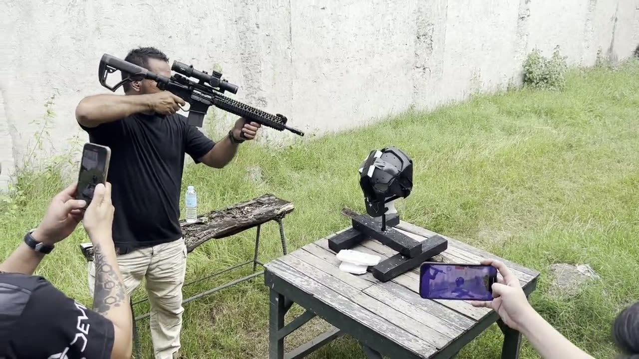 A Devtac Ronin helmet mounted on a stand at a range during a ballistic development test